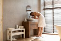 Portrait of man washing his face at bathroom